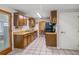 Well-lit kitchen offers wood cabinetry, ample counter space, and a view into the dining area at 211 Pierce St, Lake Wales, FL 33859