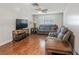Relaxing living room with wood floors, ceiling fan, and comfortable gray reclining sofas at 211 Pierce St, Lake Wales, FL 33859