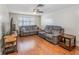 Inviting living room features laminate floors, a ceiling fan, and comfortable reclining furniture at 211 Pierce St, Lake Wales, FL 33859