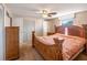 Spacious main bedroom features a decorative wood bed frame, ceiling fan, and neutral-toned walls at 211 Pierce St, Lake Wales, FL 33859