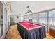 Sunroom featuring a classic pool table, carpet flooring, ample natural light, and a ceiling fan at 211 Pierce St, Lake Wales, FL 33859
