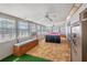 Bright sunroom with a pool table, natural light, carpet flooring, and comfortable bench seating at 211 Pierce St, Lake Wales, FL 33859