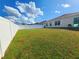 Large, fenced backyard with healthy green grass on a sunny day at 213 Tanager St, Haines City, FL 33844