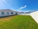 Spacious fenced backyard with lush green grass, perfect for outdoor activities and entertaining at 213 Tanager St, Haines City, FL 33844