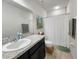 Well-lit bathroom with a sink vanity and shower with a curtain at 213 Tanager St, Haines City, FL 33844