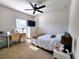 Bright bedroom with a ceiling fan, TV, and a comfortable bed with a patterned throw at 213 Tanager St, Haines City, FL 33844