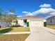 Attractive one-story house featuring a well-kept lawn and a convenient two-car garage, creating curb appeal at 213 Tanager St, Haines City, FL 33844