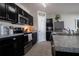 Well-appointed kitchen features sleek stainless steel appliances and dark cabinetry at 213 Tanager St, Haines City, FL 33844