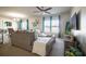 Inviting living room with neutral tones, a plush sectional, bright windows, and an adjacent dining area at 213 Tanager St, Haines City, FL 33844