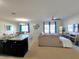 Open-concept space with a sleek kitchen island, comfortable living area, and dining space under a modern chandelier at 213 Tanager St, Haines City, FL 33844