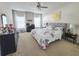 Spacious main bedroom with a tufted headboard, decorative pillows, and bright natural light at 213 Tanager St, Haines City, FL 33844
