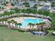 Aerial view of a community pool surrounded by palm trees and lounge chairs at 213 Tanager St, Haines City, FL 33844