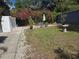 Charming backyard with patio, seating area, lush grass, and mature bougainvillea at 2222 12Th Nw St, Winter Haven, FL 33881