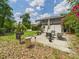 Backyard patio with seating, an umbrella, and a grill, perfect for outdoor entertaining at 2222 12Th Nw St, Winter Haven, FL 33881