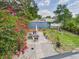Backyard featuring a lush lawn, patio, and mature trees, creating a private outdoor retreat at 2222 12Th Nw St, Winter Haven, FL 33881