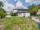 Exterior view of the property showing the backyard and second floor porch at 2222 12Th Nw St, Winter Haven, FL 33881