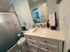 Modern bathroom featuring black and white tile flooring, a white vanity, and a glass-enclosed shower at 2222 12Th Nw St, Winter Haven, FL 33881