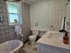 Cozy bathroom with clawfoot tub, shower, and white marble sink at 2222 12Th Nw St, Winter Haven, FL 33881