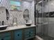 Bathroom with a double sink vanity, vessel sinks, and an updated glass-enclosed shower at 2222 12Th Nw St, Winter Haven, FL 33881