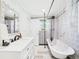Bright bathroom featuring a modern vanity, clawfoot tub, and blue patterned wallpaper at 2222 12Th Nw St, Winter Haven, FL 33881