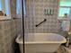 Bathroom with clawfoot tub, shower, patterned wall paper, and decor at 2222 12Th Nw St, Winter Haven, FL 33881