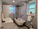 Relaxing bathroom featuring clawfoot tub, updated fixtures, and decorative patterned wallpaper at 2222 12Th Nw St, Winter Haven, FL 33881
