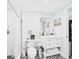 Bright bathroom with hexagon tile flooring and shower and white vanity with drawers and open shelving at 2222 12Th Nw St, Winter Haven, FL 33881
