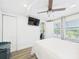 Spacious bedroom with ceiling fan, TV, and view to the outside at 2222 12Th Nw St, Winter Haven, FL 33881