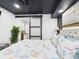 Bedroom with modern decor, tufted headboard, sliding barn door, and decorative lamps at 2222 12Th Nw St, Winter Haven, FL 33881