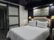Bedroom boasts a luxurious upholstered headboard, contemporary decor, and sliding barn door to living area at 2222 12Th Nw St, Winter Haven, FL 33881
