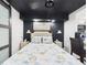 Comfortable bedroom features a large bed, stylish headboard, and sliding barn door at 2222 12Th Nw St, Winter Haven, FL 33881
