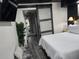 Bright bedroom features a stylish barn door, comfortable seating, and modern decor at 2222 12Th Nw St, Winter Haven, FL 33881