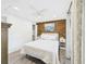 Cozy bedroom with closet, wood accent wall, ceiling fan, and hardwood floors at 2222 12Th Nw St, Winter Haven, FL 33881