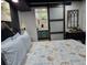 Bedroom with stylish bedspread, barn door leading to bathroom with attractive vanity at 2222 12Th Nw St, Winter Haven, FL 33881