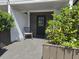 Charming entrance with a welcoming seating area and lush greenery for added privacy at 2222 12Th Nw St, Winter Haven, FL 33881