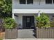 Charming entryway featuring a dark door and symmetrical planters at 2222 12Th Nw St, Winter Haven, FL 33881