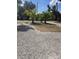 Gravel area with palms in foreground, other houses in background at 2222 12Th Nw St, Winter Haven, FL 33881