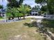 Exterior featuring a lush front yard, driveway, and well-maintained landscaping at 2222 12Th Nw St, Winter Haven, FL 33881
