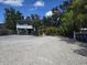 Exterior view of house showing gravel parking area and tropical foliage at 2222 12Th Nw St, Winter Haven, FL 33881