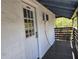 Exterior door leading to a covered walkway with lush green foliage in the background at 2222 12Th Nw St, Winter Haven, FL 33881