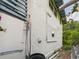 Exterior side view of the home showing the stucco wall and a metal ladder at 2222 12Th Nw St, Winter Haven, FL 33881