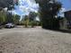 Driveway and parking area surrounded by lush landscaping and trees at 2222 12Th Nw St, Winter Haven, FL 33881