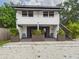 Inviting two-story home featuring cozy covered seating and lush landscaping at 2222 12Th Nw St, Winter Haven, FL 33881