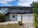 Charming exterior view featuring balcony, stairs, and secure storage at 2222 12Th Nw St, Winter Haven, FL 33881
