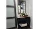 Hallway showing accent mirror and a stylish dresser with a modern sliding barn door at 2222 12Th Nw St, Winter Haven, FL 33881