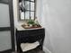 Hallway showing accent mirror and a stylish dresser with a modern sliding barn door at 2222 12Th Nw St, Winter Haven, FL 33881