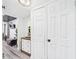 Hallway featuring closet doors and a view into a tastefully decorated bedroom at 2222 12Th Nw St, Winter Haven, FL 33881