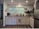Bright kitchen with granite countertops, white cabinets and stainless steel appliances at 2222 12Th Nw St, Winter Haven, FL 33881