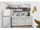 Bright kitchen with stainless steel refrigerator and neutral mosaic tile backsplash at 2222 12Th Nw St, Winter Haven, FL 33881