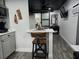 Modern kitchen with a breakfast bar, wood floors, gray cabinets, and stainless steel appliances at 2222 12Th Nw St, Winter Haven, FL 33881